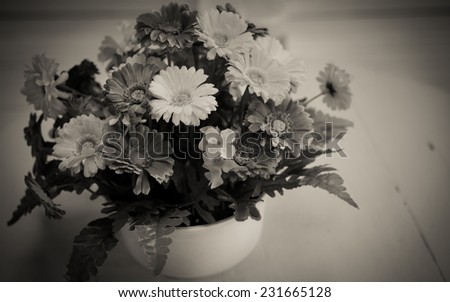 Beautiful flowers in a vase on white table vintage style.