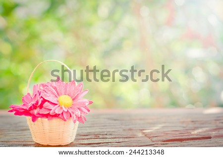 Flowers in a basket  on a wooden with bokeh background in a vintage retro style, with the sunrise, for the day of love, Valentine\'s Day.