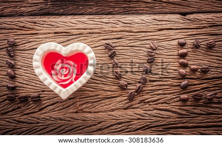 White heart with coffee beans on wooden background in vintage tone soft focus (love coffee)