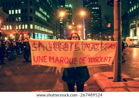 MONTREAL - Over 50,000 students are on strike in Quebec. A young woman holds up a hand-painted sign during a protest in Montreal.
