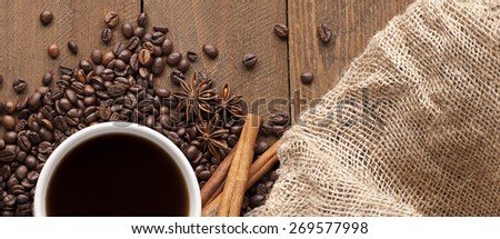 Photo of a Cup of coffee on wooden table. Warm natural morning light.