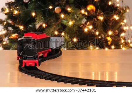 Train with christmas tree in the background.
