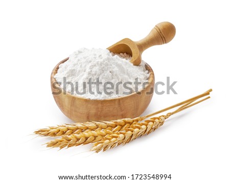 Wheat flour in bowl and spikelets isolated on white