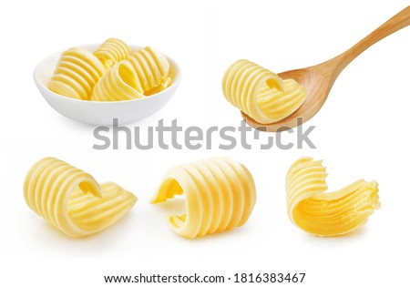 Set of butter curl on wooden spoon. Butter roll in white bowl isolated on white.