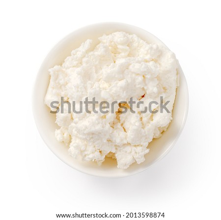 Fresh ricotta cheese in white bowl isolated. Ricotta soft cheese on white background. Cheese for package design.