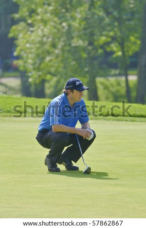 TORONTO, ONTARIO - JULY 21 : South African golfer Tim Clark lines up a putt during a pro-am event at the RBC Canadian Open golf on July 21, 2010 in Toronto, Ontario.