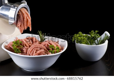 Bowl of mince with electric meat grinder, mortar and pestle