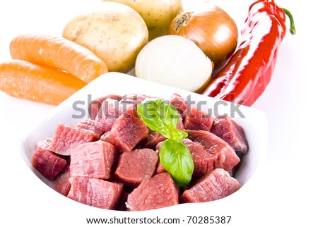 Diced beef with vegetables over white background