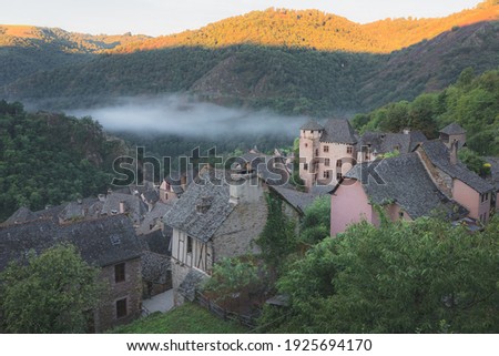 Hillside view of the quaint and charming medieval French village of Conques, Aveyron, a popular summer tourist destination in the Occitanie region of France. Photo stock © 