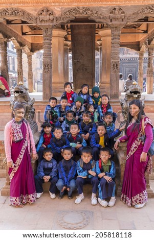 BHAKTAPUR, NEPAL - DEC 2, 2013: young nepalese unidentified students on a school trip on December 2, 2013 in Bhaktapur, Kathmandu valley, Nepal