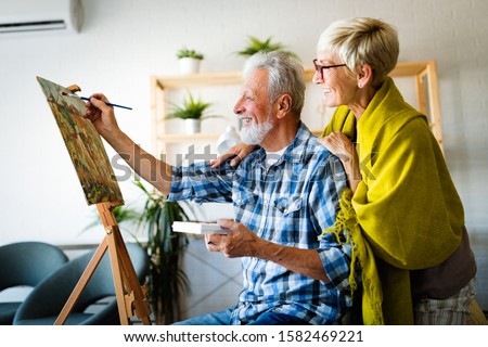 Similar – Image, Stock Photo Older woman painting on a notebook