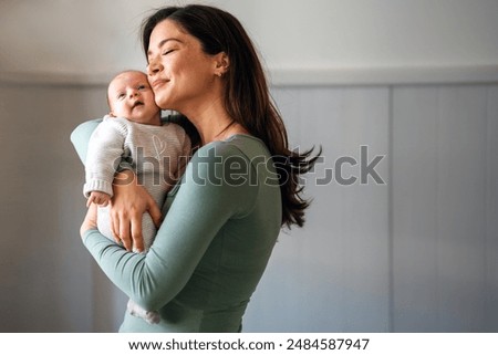 Similar – Image, Stock Photo Adorable mother and child on hand enjoying and laughing in field