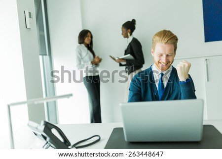 Successful businessman being happy for achieving his goals as he sees promising results on the laptop in front of him