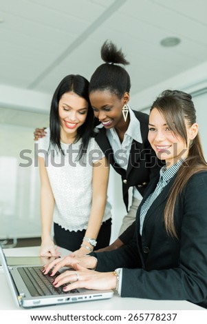 Businesswomen exchanging thoughts in a nice office environment while working on a laptop