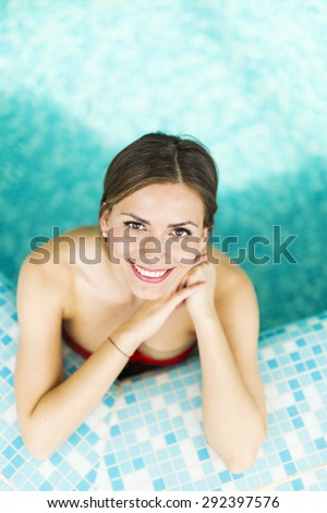 Beautiful brunette posing in swimming pool