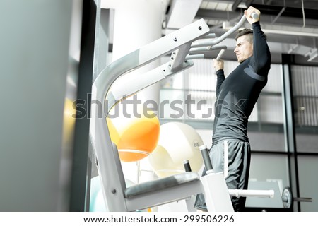 Young handsome man working out in a  gym and living a healthy lifestyle