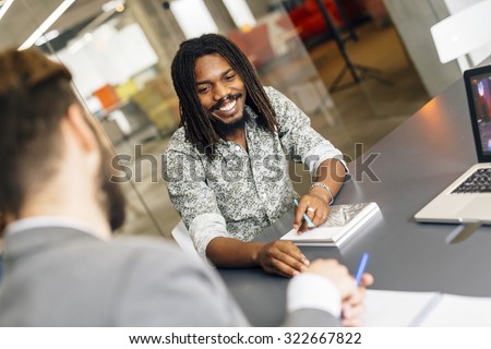 Black handsome employee smiling in office