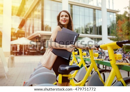 Similar – Image, Stock Photo Woman renting bike using rental app on mobile phone. Using bike sharing city service. Paid rent of electric scooter. Using smartphone to rent and pay for public eco transport
