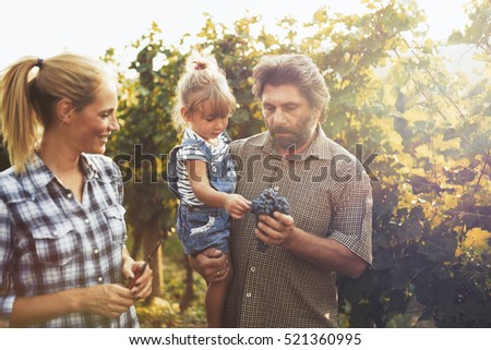 Similar – Image, Stock Photo Winegrower and daughter with bucket of grapes in countryside