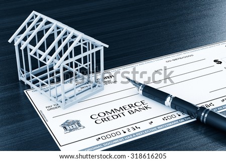 Bank Check with House Frame and pen on the table