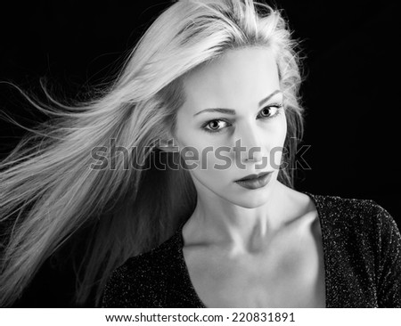 Beautiful model with blonde hair on black background. Black and white version.