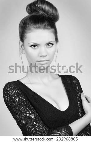 Portrait of attractive young woman with beautiful bridal hairstyle with tress, rear view. Black and White