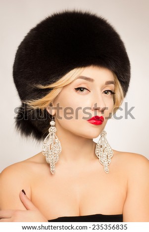 Jewelry and Beauty. Beautiful woman model wearing in fur hat. Fashion lady photo.Winter Girl. Fur Fashion. Beautiful Woman in Fur Hat. Winter Woman Portrait