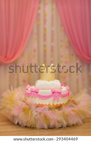 Elegant sweet table with big cake, cupcakes, cake pops on dinner or event party. Cake pops. Tray with delicious cakes and macaroon
