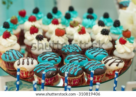Tray with delicious cakes. Elegant sweet table with big cake, cupcakes, cake pops on dinner or event party. Cake pops. Tray with delicious cakes
