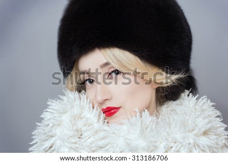 Winter Fashion Woman in Luxury Fur Coat. Beauty Fashion Model Girl. Beautiful winter girl in winter knitted hat and scarf