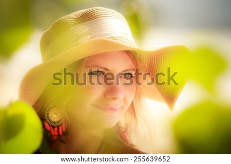 blonde long haired blue eyed girl in straw hat portrait closeup