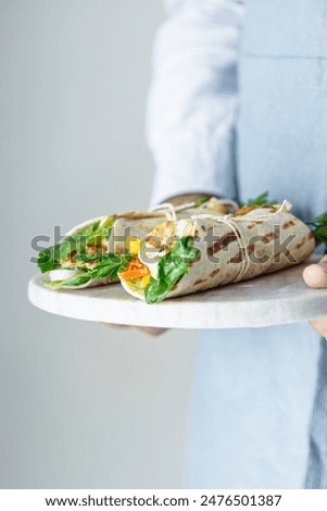 Similar – Image, Stock Photo Tortilla wraps sandwiches preparation with tasty fresh avocado salsa salad on white background, top view. Healthy food.  Vegetarian lunch or snack