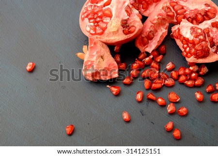 Pomegranate background. Pomegranate core on dark background, top view. Healthy fruit eating. Copy Space