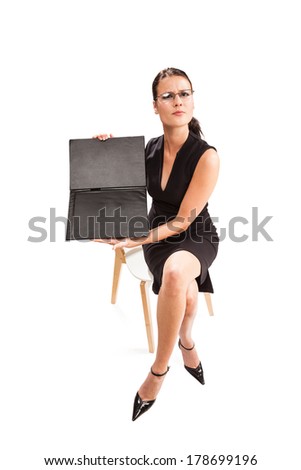 Serious female sitting on the chair closes document case in front of her
