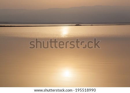Dead Sea beautiful seascape with golden sunrise reflected in water.