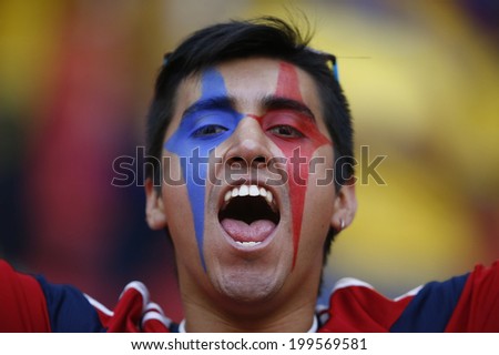 BRASILIA, BRAZIL - June 19, 2014: Soccer fans celebrating at the 2014 World Cup Group C game between Colombia and Ivory Coast at Estadio Nacional. NO USE IN BRAZIL.