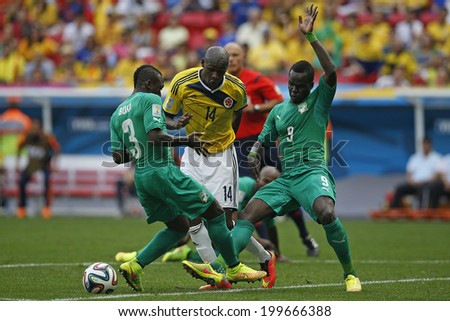 BRASILIA, BRAZIL - June 19, 2014: Ibarbo of Colombia and Tiote of Ivory Coast compete for the ball during the World Cup game between Colombia and Ivory Coast at Estadio Nacional. No Use in Brazil.