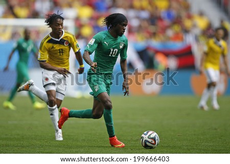 BRASILIA, BRAZIL - June 19, 2014: Cuadrado of Colombia and Gervinho of Ivory Coast compete for the ball during the game between Colombia and Ivory Coast at Estadio Nacional. No Use in Brazil.