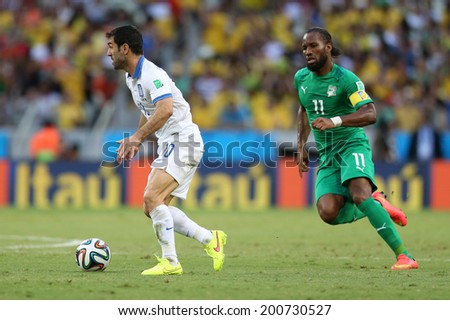 FORTALEZA, BRAZIL - JUNE 24, 2014: Karagounis of Greece and Drogba of Ivory Coast during the World Cup Group C game between Greece and Ivory Coast at the Castelao stadium. NO USE IN BRAZIL.