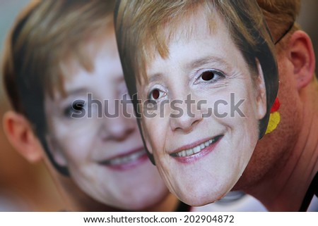 RIO DE JANEIRO, BRAZIL - JULY 04, 2014: Soccer fans of Germany with Angela Merkel masks during the World Cup Quarter-finals game between France and Germany in the Estadio Maracana. NO USE IN BRAZIL.