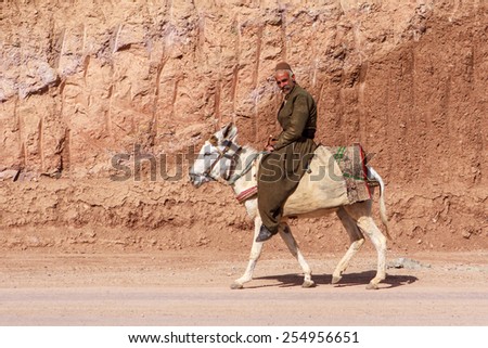 IRAN, KURDISTAN - MAY 19, 2012: Unidentified kurdish man riding donkey in Kurdistan