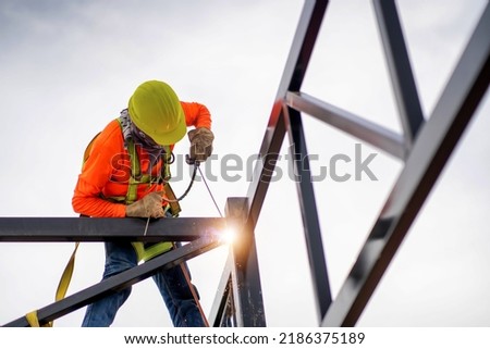 Similar – Image, Stock Photo welder is welding metal part in garage. with protective mask,