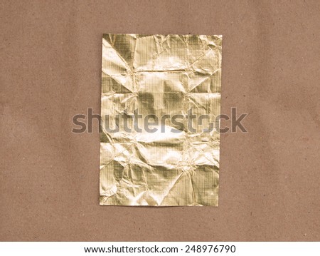 gold foil on brown paper