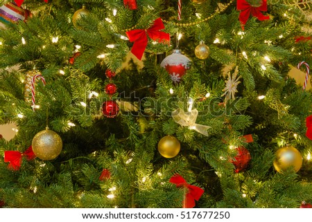 classic christmas decorations in red and golden yellow on pine tree in evening light close - Classic Christmas Tree Decorations classic christmas decorations in red and golden yellow on pine tree in evening light close - Classic Christmas Tree Decorations
