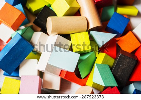 Heap of toy colored wooden bricks background