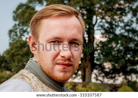 Portrait of handsome ginger hair man dressed in regency period costume. Image with selective focus