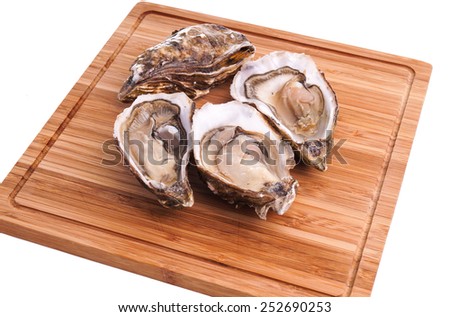 Gourmet fresh french oysters on a wooden board