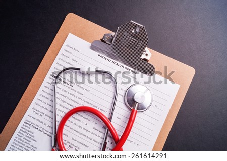 Medical Chart and stethoscope isolated on black background