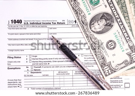 Tax form and Money. Filling the forms and hoping for a tax refund return