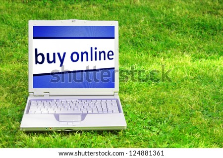 buy online or ecommerce concept with laptop in green grass
